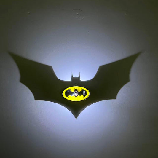 3D-printed Batman shadow lamp product showcase with yellow and black Bat logo.