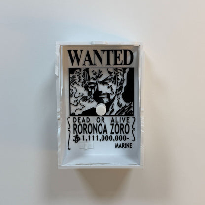 3D printed Roronoa Zoro 'Wanted Dead or Alive' poster, repurposed as a functioning single toggle light switch cover, featuring his Wano arc bounty and portrait. zoro shadow lamp