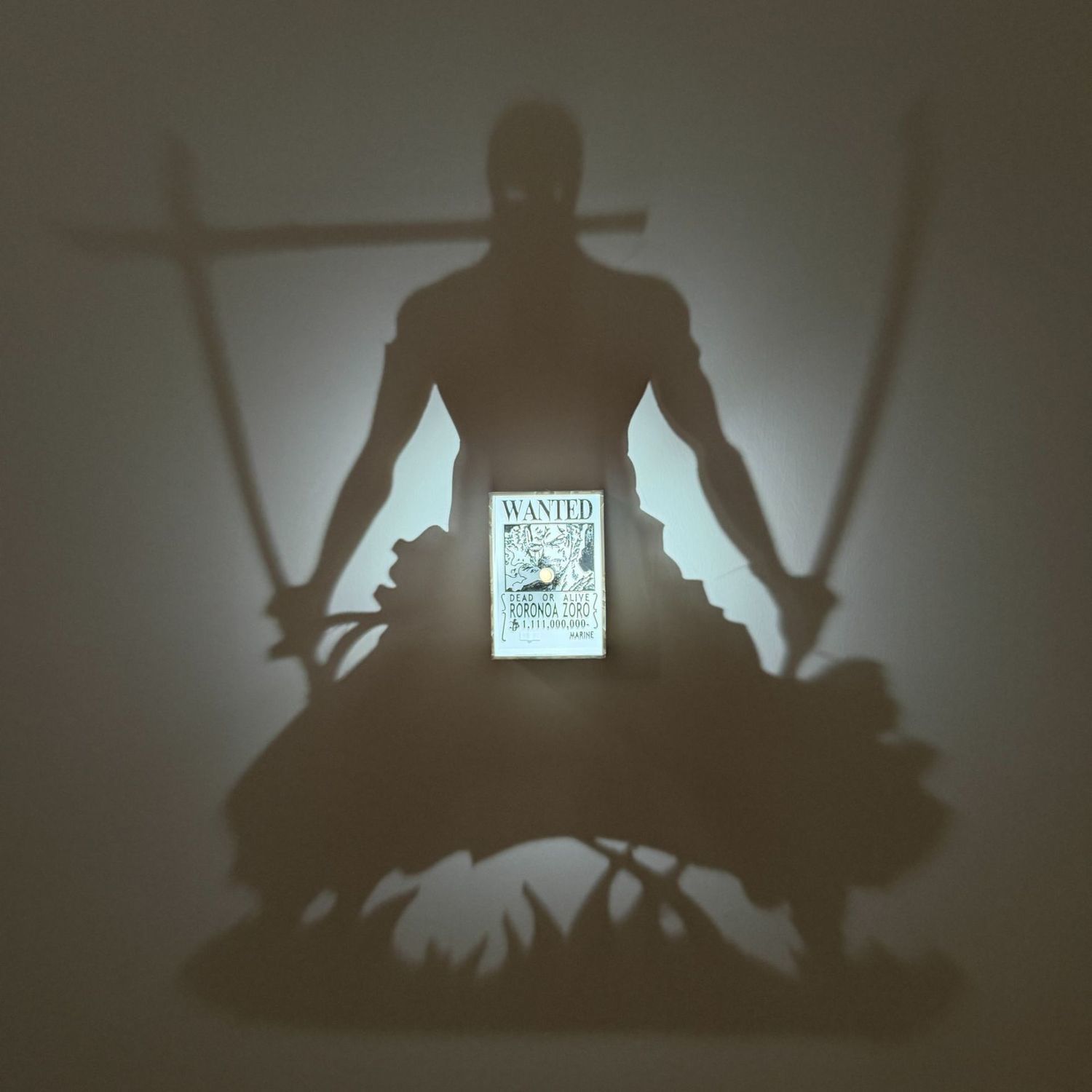 High-quality product image of a custom 3D printed light switch plate designed as Roronoa Zoro's bounty poster. The switch is the central focal point, surrounded by realistic One Piece memorabilia, including the Marine flag and golden coins.